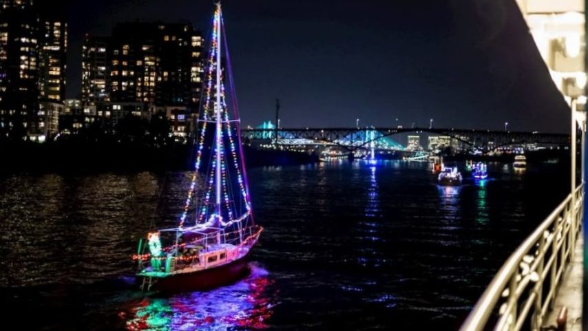 Portland Spirit Ship passing a lighted/decorated sailboat on the Willamette River