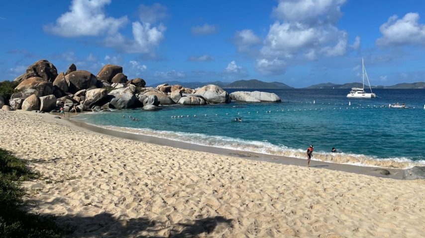 Sandy beach in the Virgin Islands with boat anchored off shore