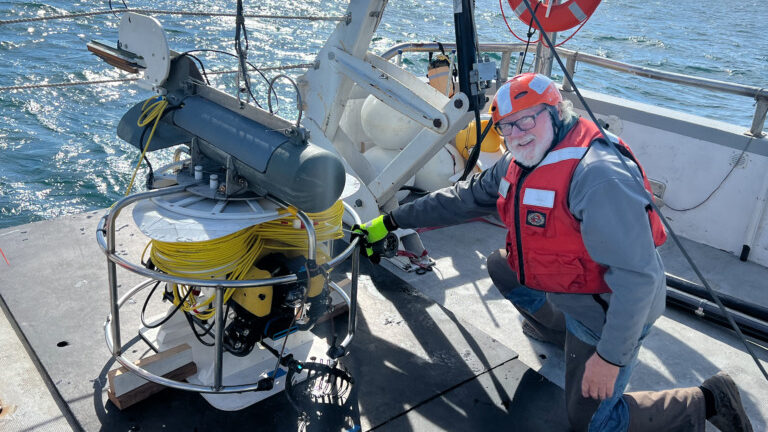 Photo of team member with ROV sonar equipment