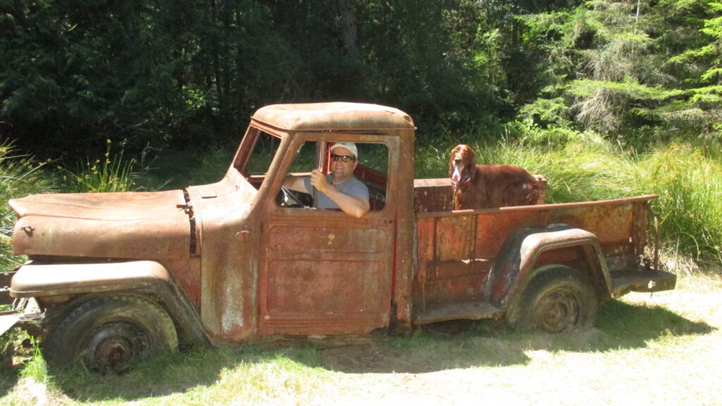 Visitor sitting in the old truck on Wallace Island
