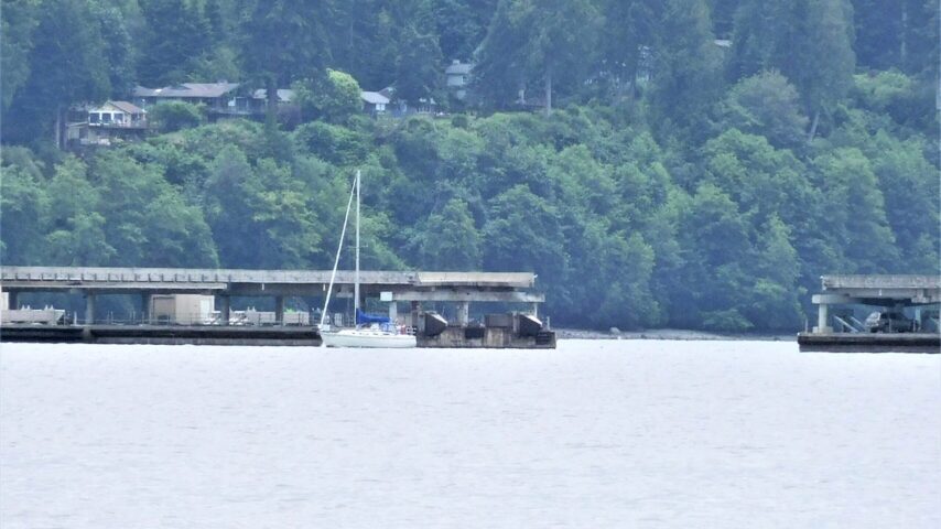 Sailboat passing through draw span; pyramids viewable on east center end