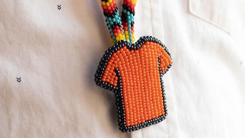 Native art necklace of a beaded orange shirt