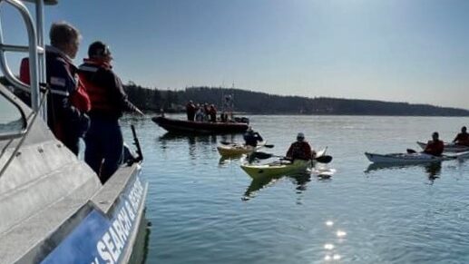 Skagit Search & Rescue vessel early morning, kayakers in the distance