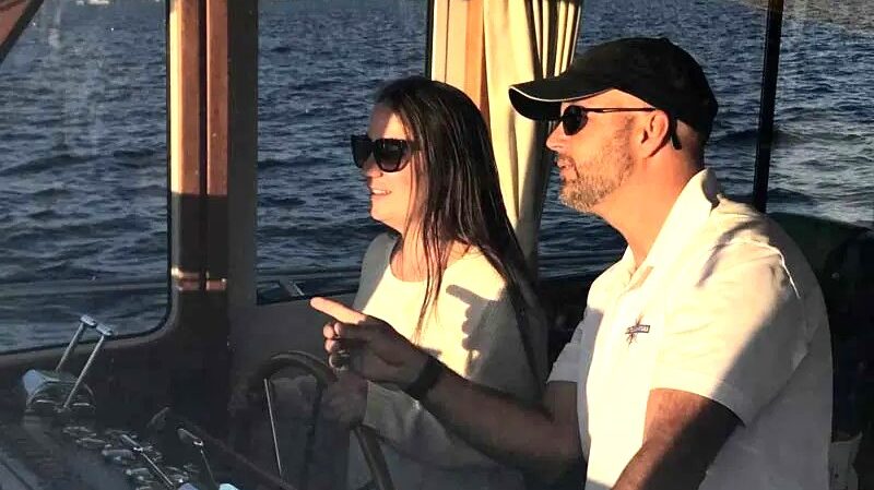 Instructor with student at helm of power boat