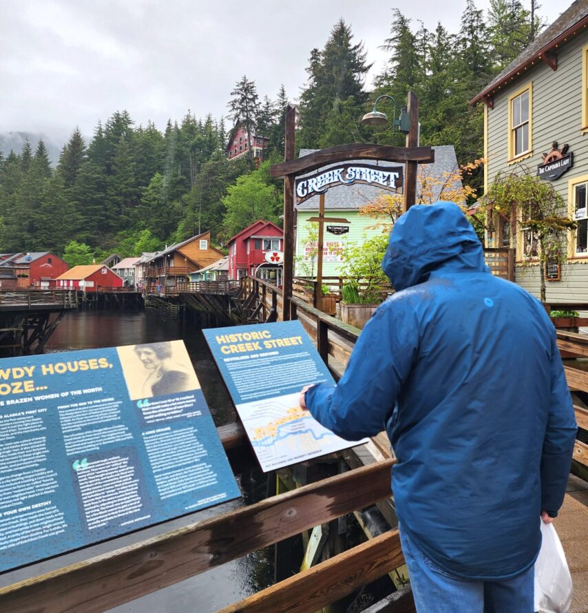 Walking Creek Street in Ketchikan and reading the Reader Boards