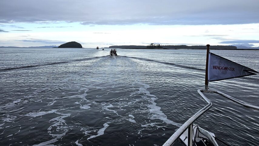Flotilla of boats on their way to Ketchikan with Waggoner Burgee