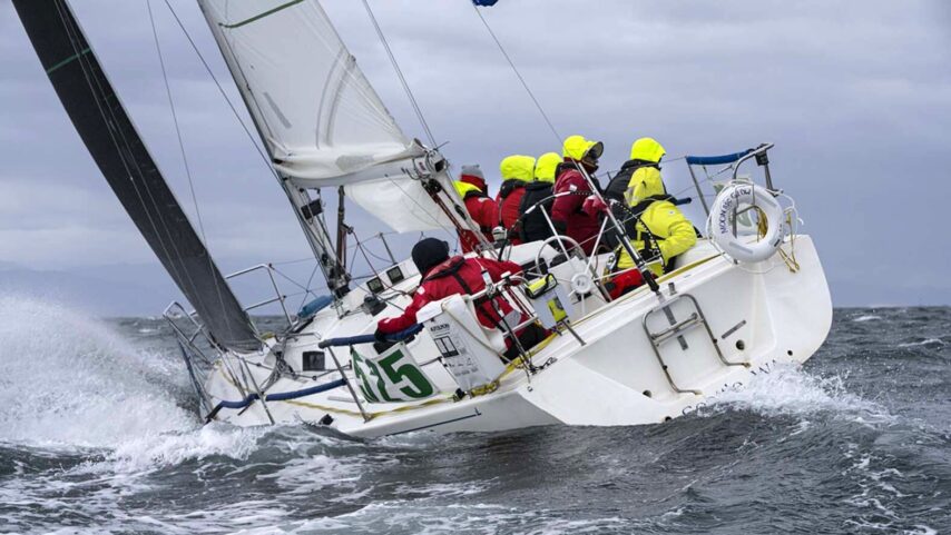 Racing team aboard sailboat healed over during the race