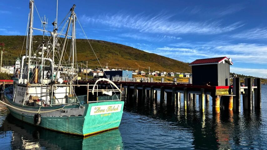 Fish boat with village of Nain in background