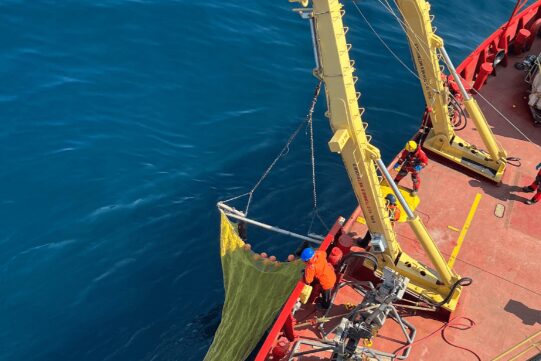 Amundsen using crane to collect specimens with a net