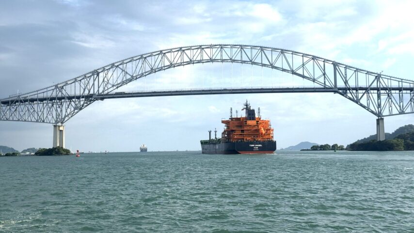 Photo of container ship going under the Bridge of the Americas