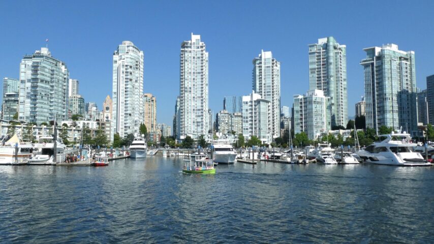 Photo of Vancouver BC skyline with boats and marinas in foreground.
