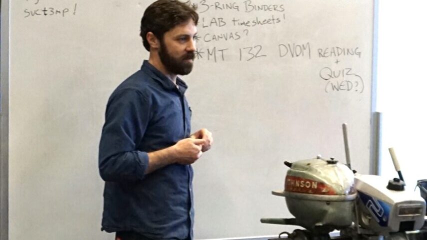 Photo of instructor showing outboard motors