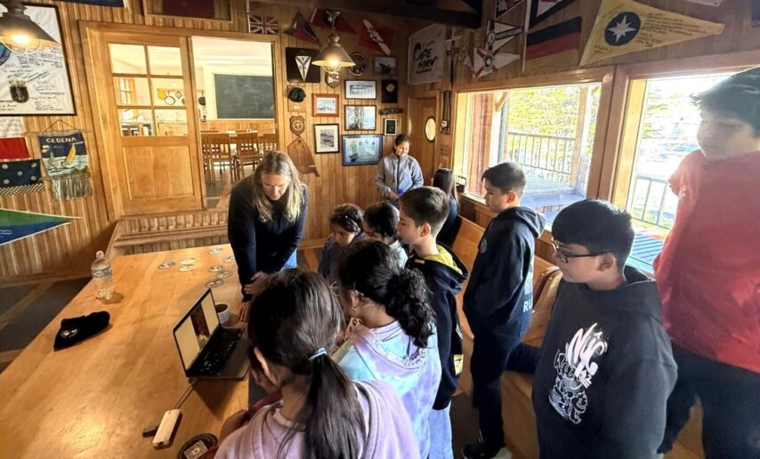 Photo of Jenn Dalton with students in the school's classroom at Puerto Williams