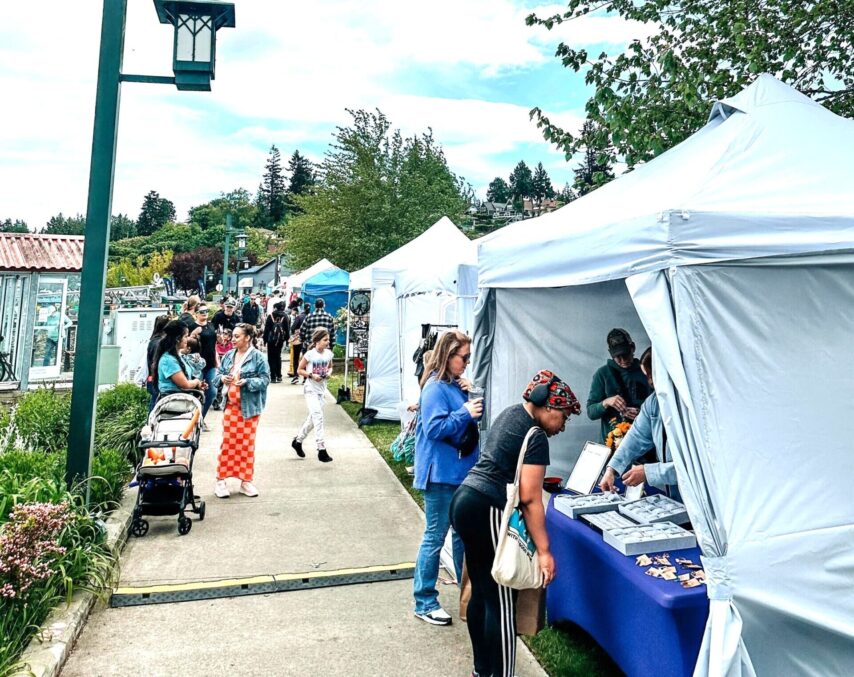 People shopping at the market tents at Port Orchard Marina